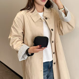 Model holding Black mini wristlet