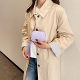 Model holding Lavender mini wristlet