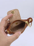 Open purse showing the natural suede-textured leather interior and metal zipper