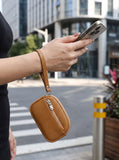Model wearing the tan coin purse around her wrist
