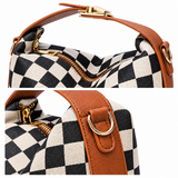 Close-up of checkerboard texture, zipper closure, brown PU trim and gold-tone attachment ring.