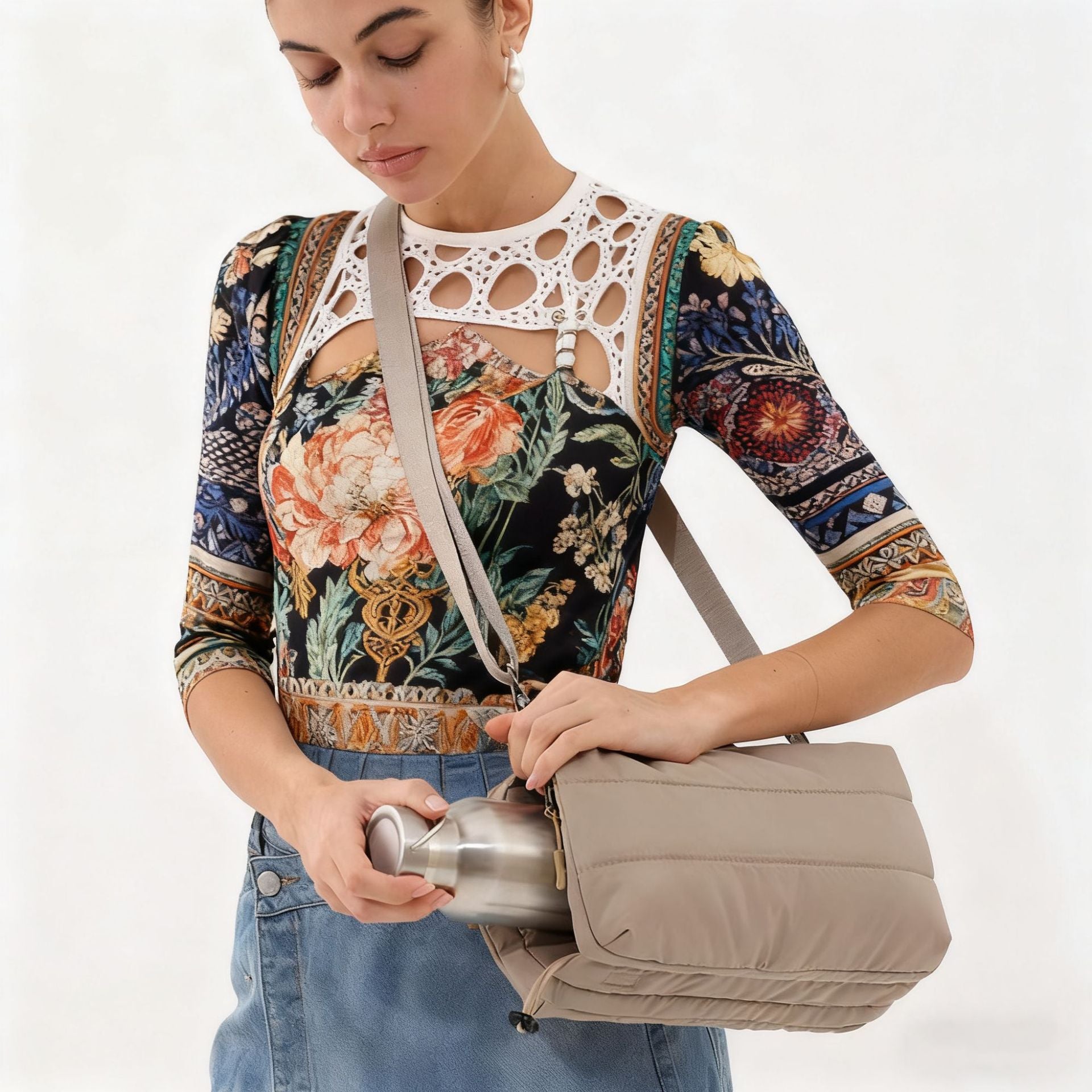 Model wearing the khaki crossbody bag and using its bottle section