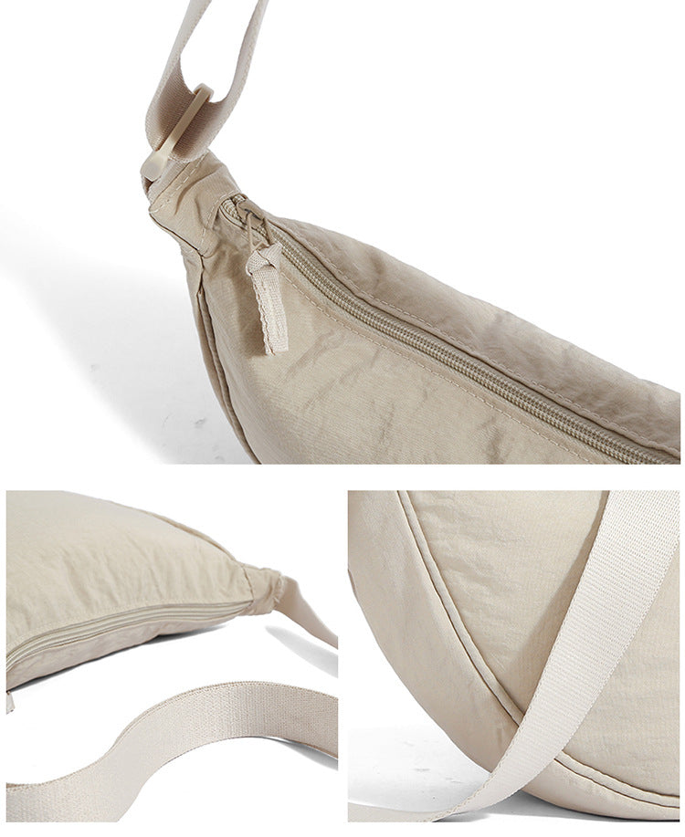 Crescent bag zipper, adjustable woven strap and seam details