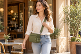 Olive green wallet styled as a compact crossbody with a cream shirt and jeans