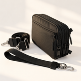 black nylon wallet in three-quarter side view with matching wristlet and crossbody straps