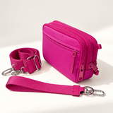 magenta nylon wallet in three-quarter side view with matching wristlet and crossbody straps