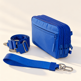 blue nylon wallet in three-quarter side view with matching wristlet and crossbody straps