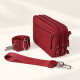 burgundy nylon wallet in three-quarter side view with matching wristlet and crossbody straps