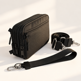 black nylon wallet in three-quarter side view with matching wristlet and crossbody straps