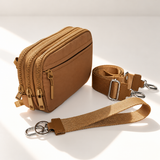 brown nylon wallet in three-quarter side view with matching wristlet and crossbody straps