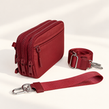 burgundy nylon wallet in three-quarter side view with matching wristlet and crossbody straps