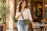 Olive green wallet styled as a compact crossbody with a cream shirt and jeans