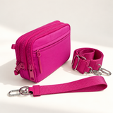 magenta nylon wallet in three-quarter side view with matching wristlet and crossbody straps