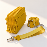 yellow nylon wallet in three-quarter side view with matching wristlet and crossbody straps